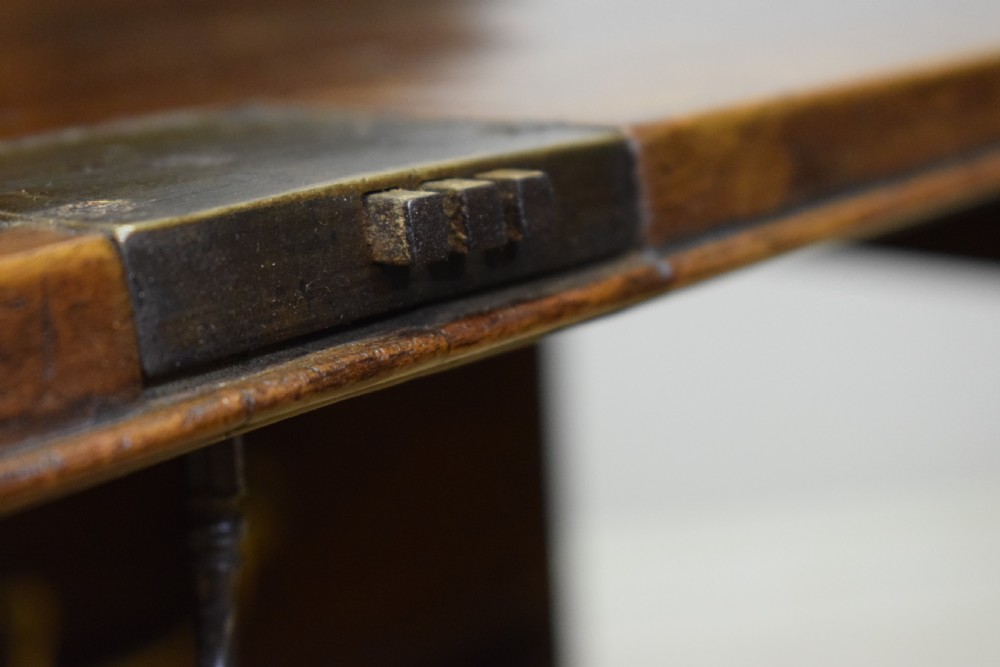 A Georgian walnut bureau featuring a sloped hinged front opening above four graduated drawers with decorative brass handles and bracket feet. View XVIII