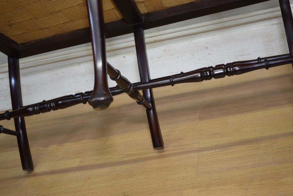 A late Victorian dark mahogany double chair-back settee featuring pierced splats, curved arms, cabriole front legs, and a patterned fabric seat. View XVI
