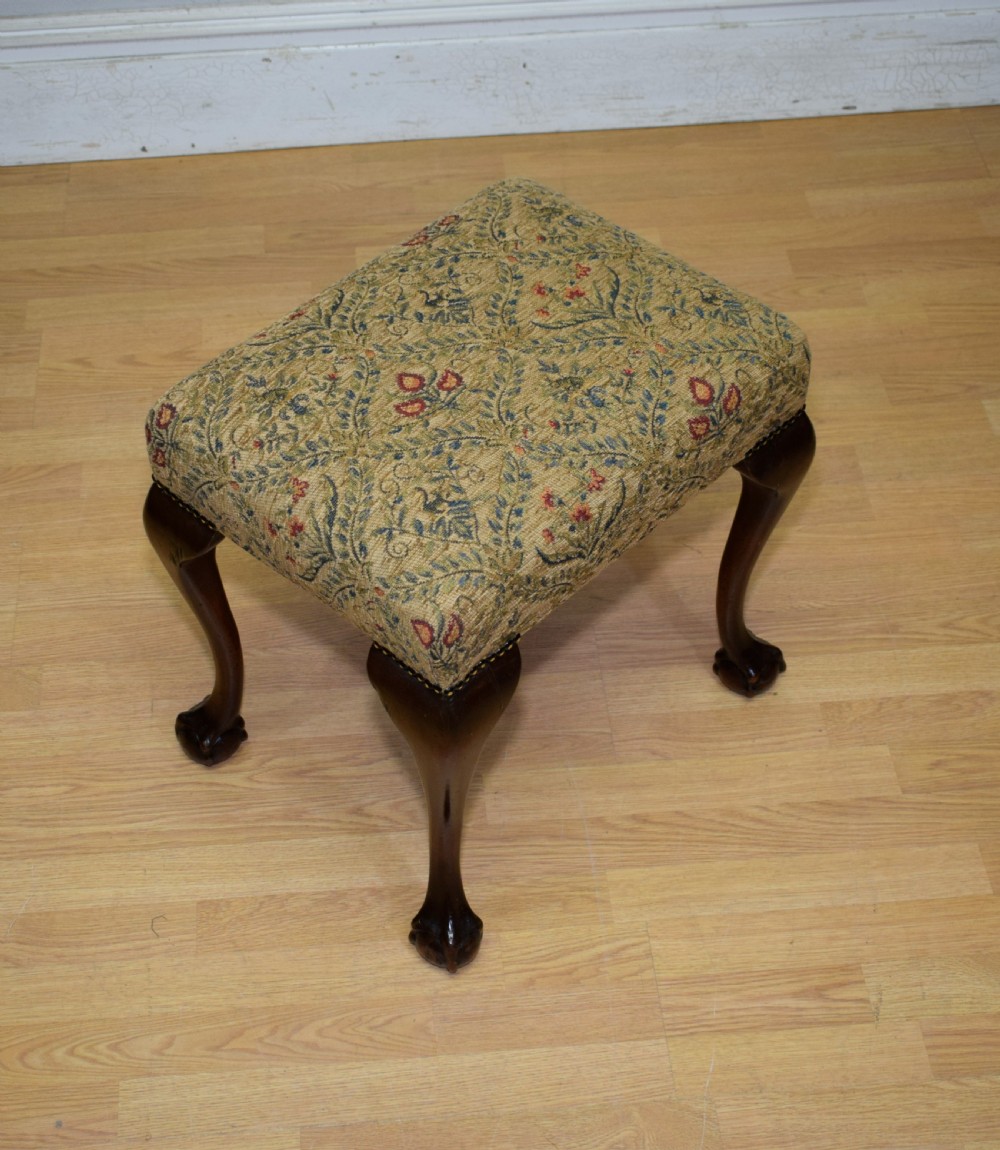 A square Chippendale style stool upholstered in floral patterned fabric with dark mahogany cabriole legs and claw-and-ball feet. View III