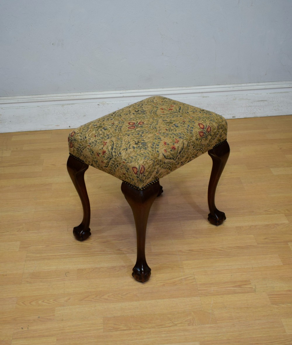A square Chippendale style stool upholstered in floral patterned fabric with dark mahogany cabriole legs and claw-and-ball feet. View IV