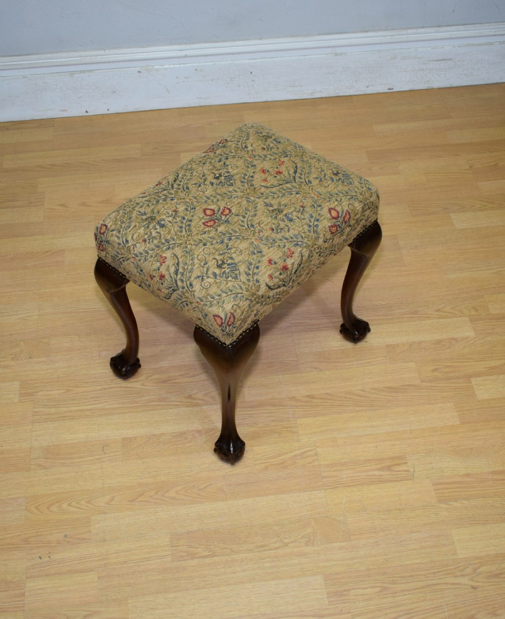 A square Chippendale style stool upholstered in floral patterned fabric with dark mahogany cabriole legs and claw-and-ball feet. View VI