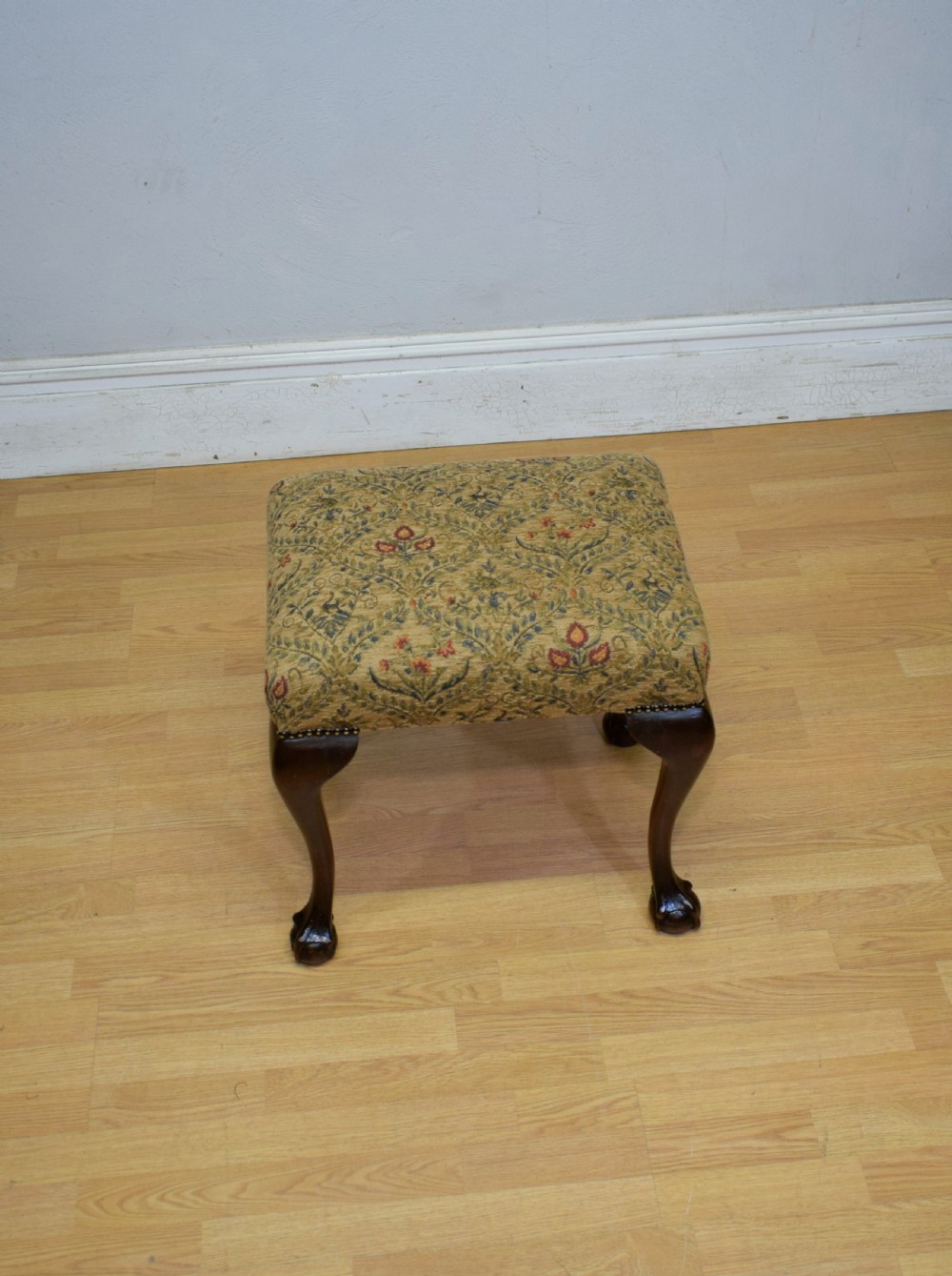 A square Chippendale style stool upholstered in floral patterned fabric with dark mahogany cabriole legs and claw-and-ball feet. View IX
