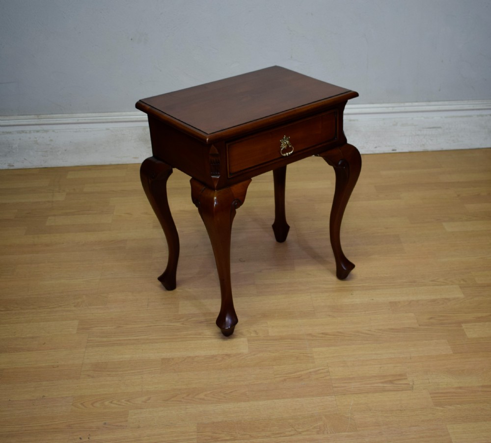 An early 20th-century mahogany lamp table featuring a single drawer with a brass drop ring handle and four cabriole legs ending in pad feet. View V