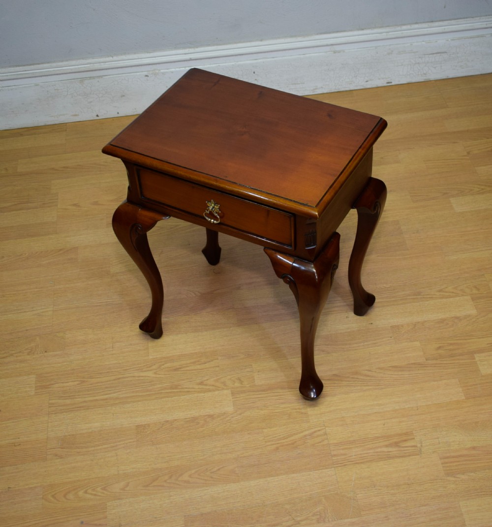 An early 20th-century mahogany lamp table featuring a single drawer with a brass drop ring handle and four cabriole legs ending in pad feet. View VI