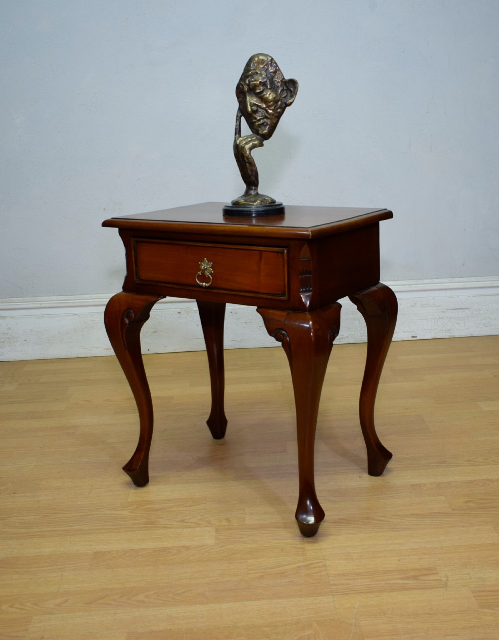 An early 20th-century mahogany lamp table featuring a single drawer with a brass drop ring handle and four cabriole legs ending in pad feet. View VIII