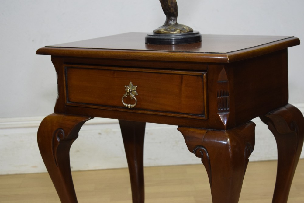 An early 20th-century mahogany lamp table featuring a single drawer with a brass drop ring handle and four cabriole legs ending in pad feet. View IX