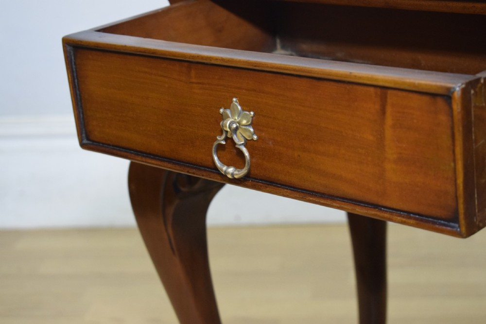 An early 20th-century mahogany lamp table featuring a single drawer with a brass drop ring handle and four cabriole legs ending in pad feet. View XII