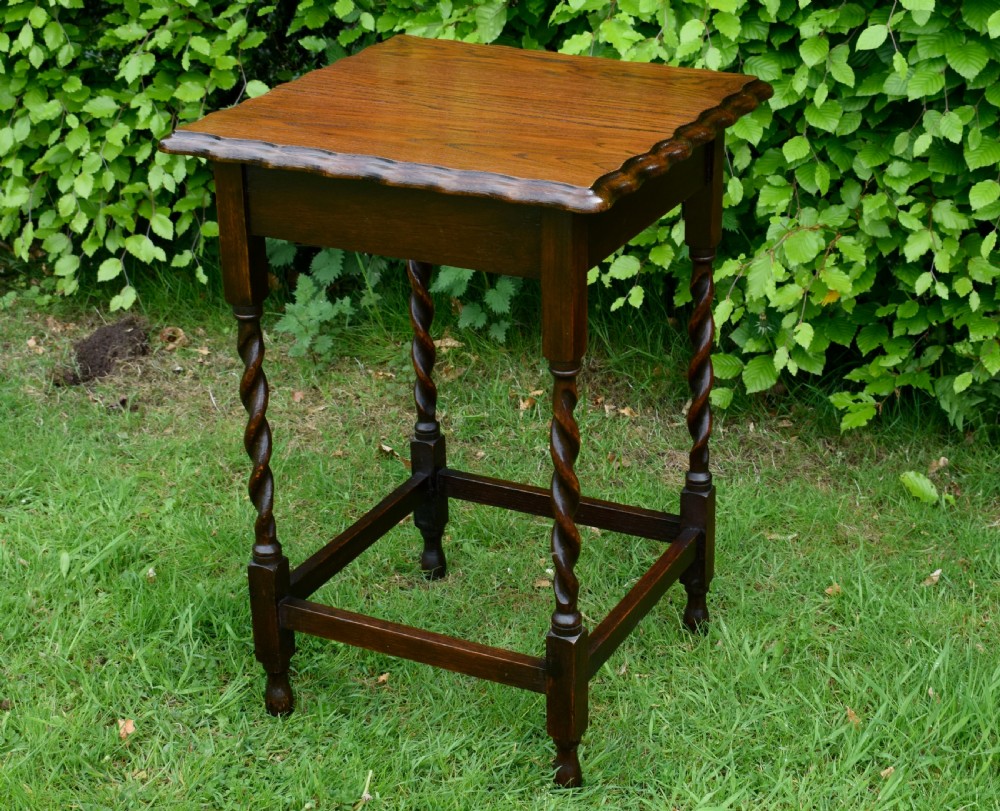 A dark brown square oak side table featuring a scalloped piecrust edge, four barley twist turned legs, and a lower square stretcher frame. View III