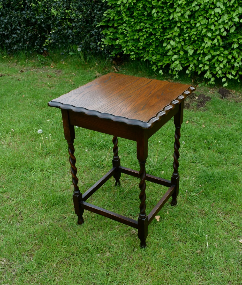 A dark brown square oak side table featuring a scalloped piecrust edge, four barley twist turned legs, and a lower square stretcher frame. View V