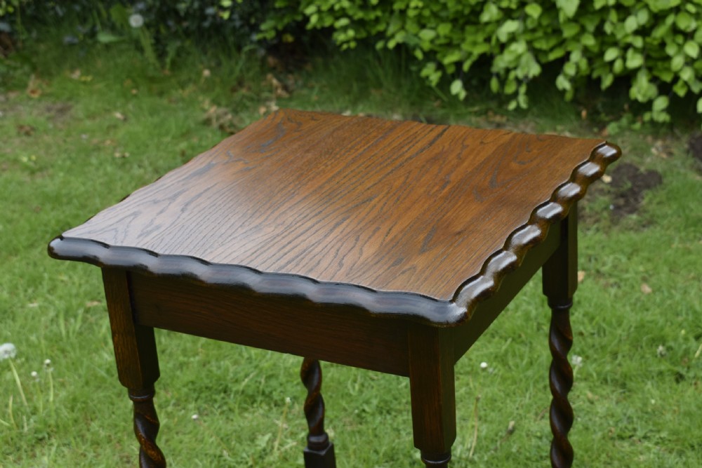 A dark brown square oak side table featuring a scalloped piecrust edge, four barley twist turned legs, and a lower square stretcher frame. View VI