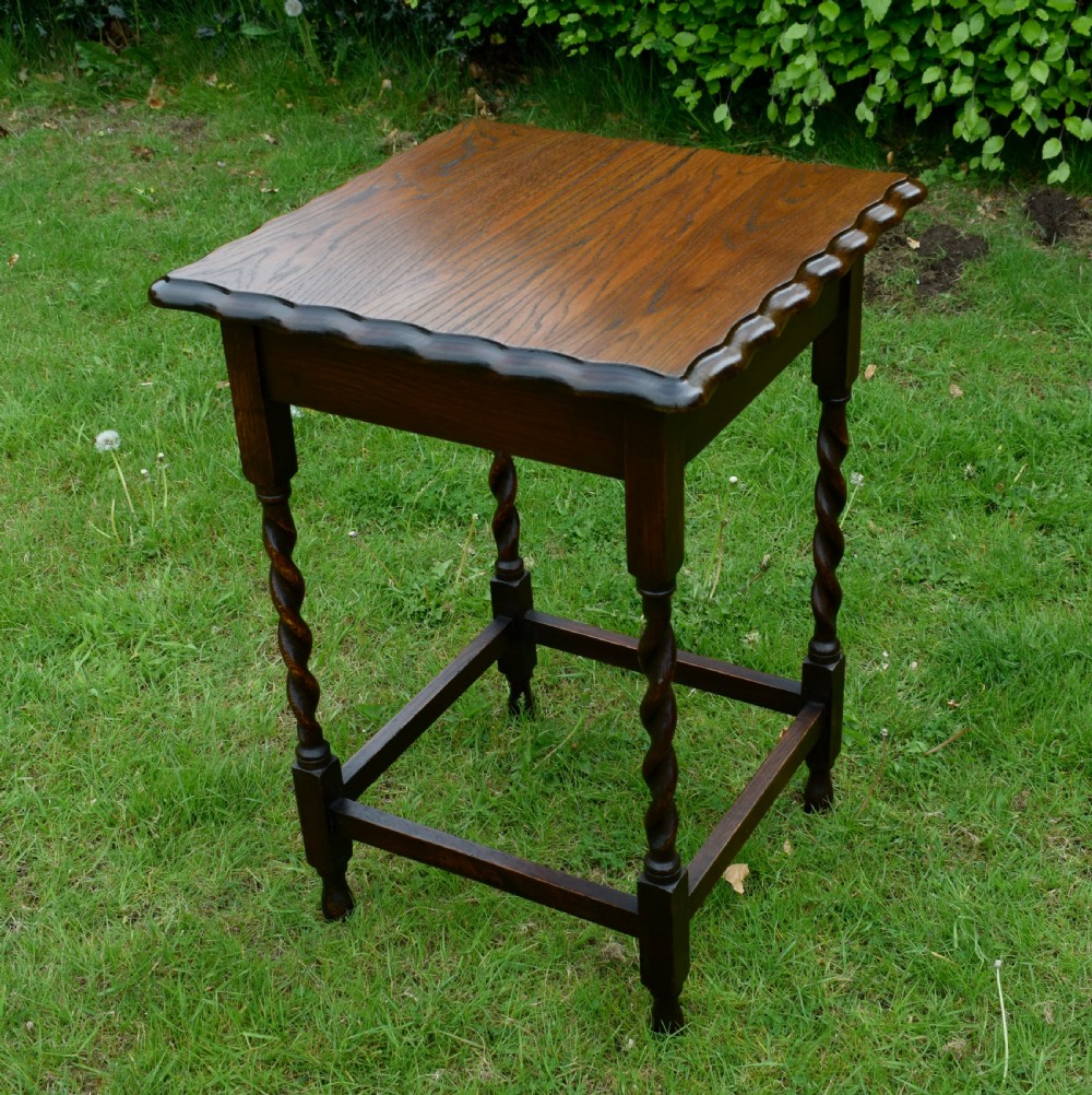 A dark brown square oak side table featuring a scalloped piecrust edge, four barley twist turned legs, and a lower square stretcher frame. View VII