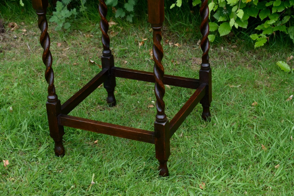 A dark brown square oak side table featuring a scalloped piecrust edge, four barley twist turned legs, and a lower square stretcher frame. View X