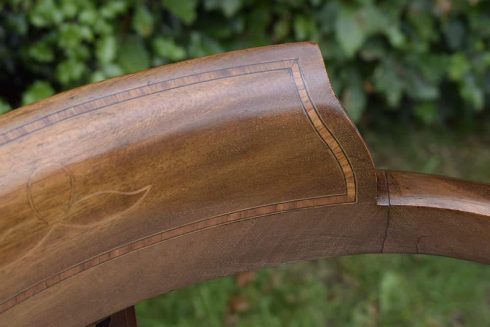 An Edwardian mahogany tub armchair featuring satinwood inlay, pierced lattice back splats, curved arms, and a light pattern-upholstered seat. View V