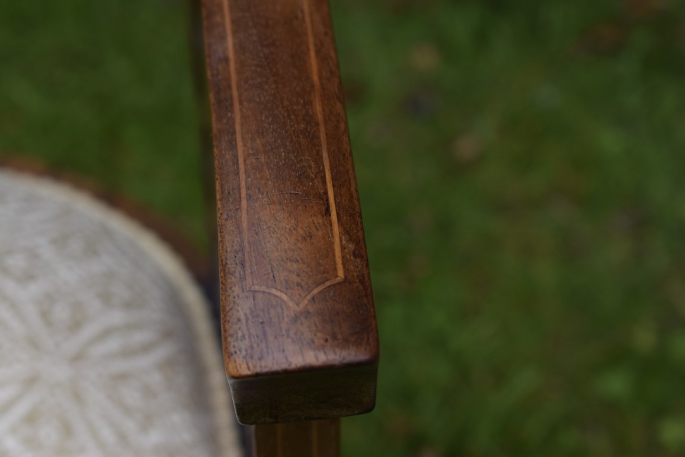 An Edwardian mahogany tub armchair featuring satinwood inlay, pierced lattice back splats, curved arms, and a light pattern-upholstered seat. View VI