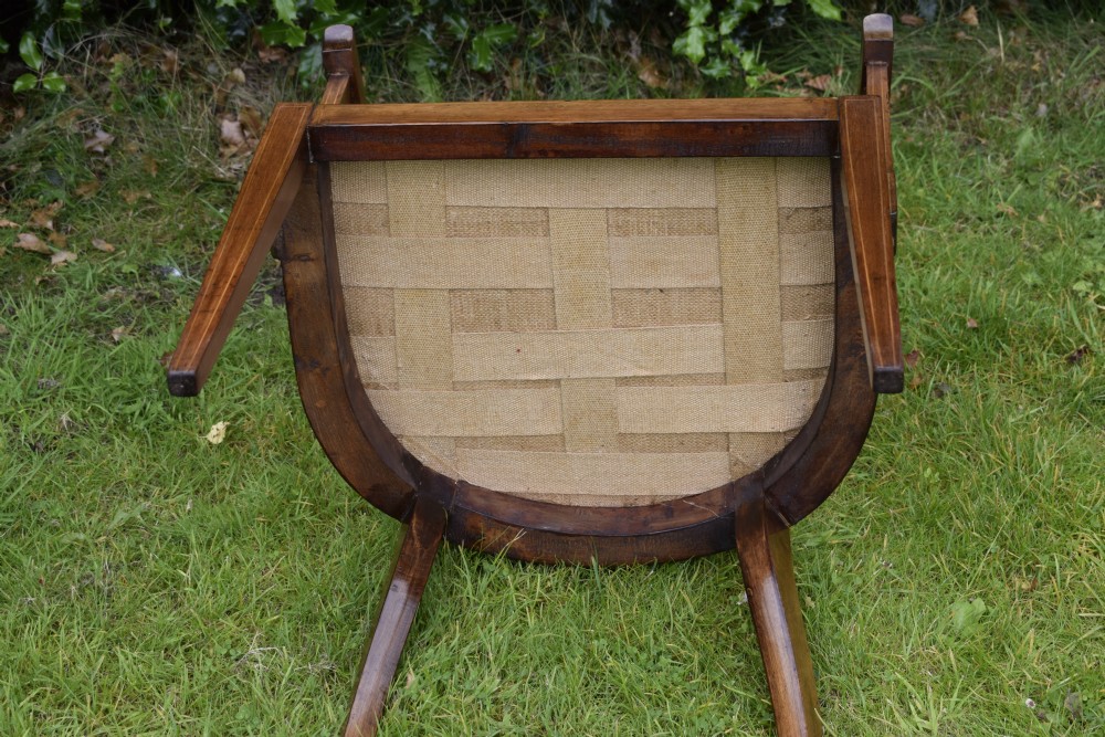 An Edwardian mahogany tub armchair featuring satinwood inlay, pierced lattice back splats, curved arms, and a light pattern-upholstered seat. View XIII