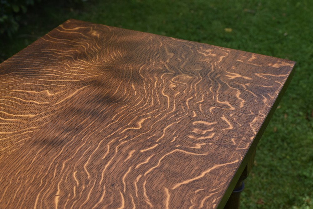 A tall rectangular dark oak side table featuring turned legs, a shaped apron, and lower perimeter box stretchers. View XI