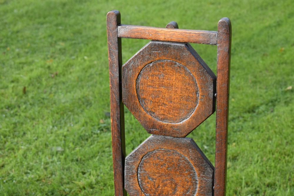An early 20th-century dark oak three-tier folding cake stand featuring octagonal wooden platforms supported by a slender timber frame. View X