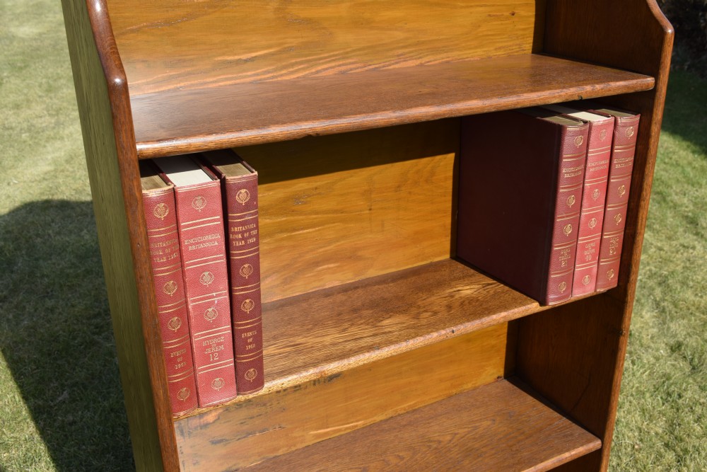 A tall early 20th-century open-front oak bookcase featuring four fixed shelves and a shaped top gallery. View VIII