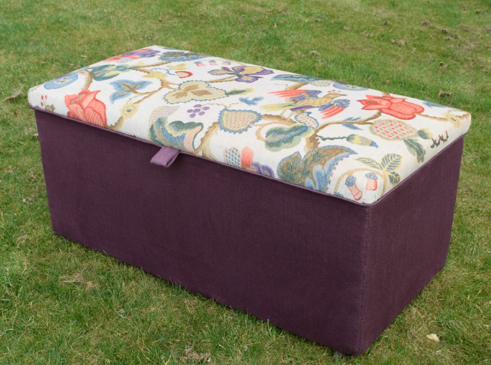 A rectangular Victorian upholstered storage ottoman featuring a deep purple base and a floral patterned fabric lid. View III