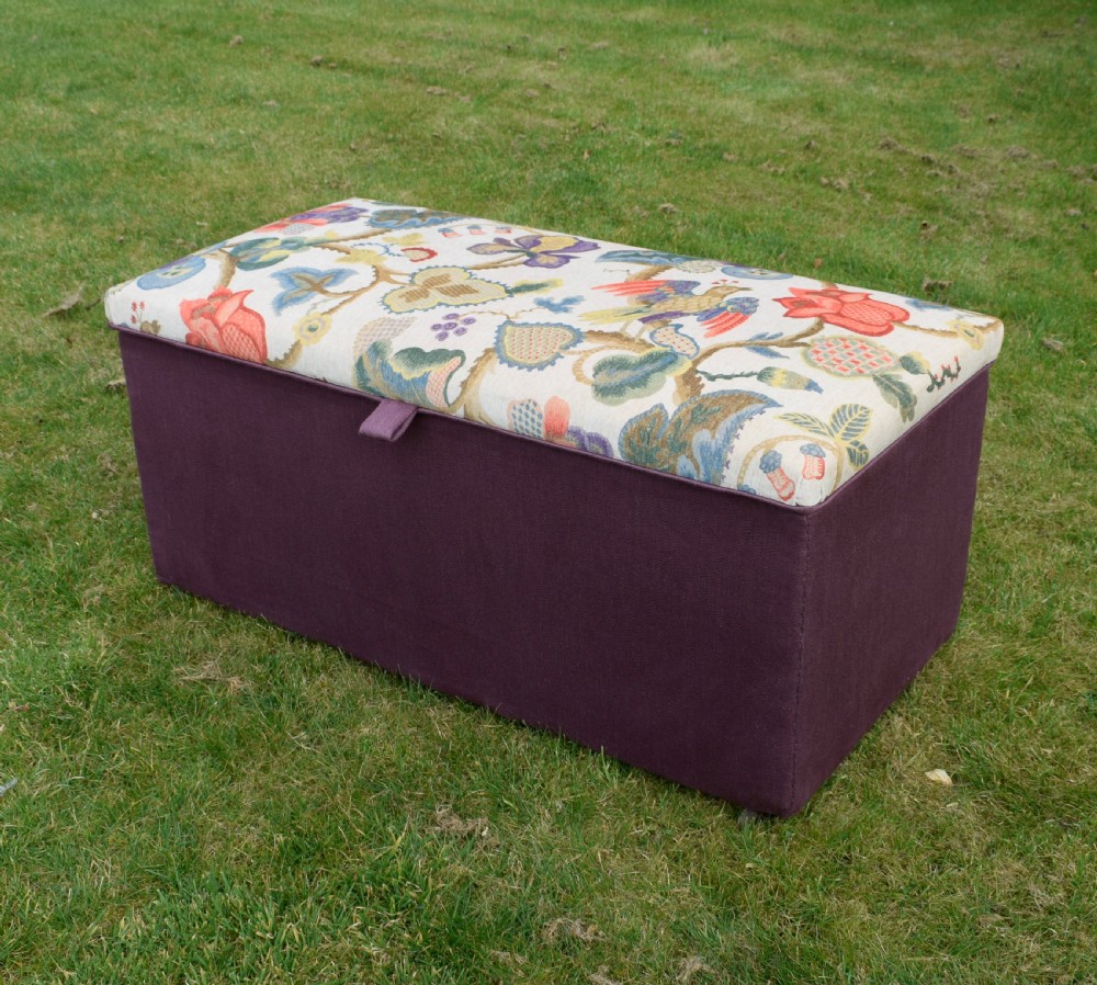 A rectangular Victorian upholstered storage ottoman featuring a deep purple base and a floral patterned fabric lid. View VII