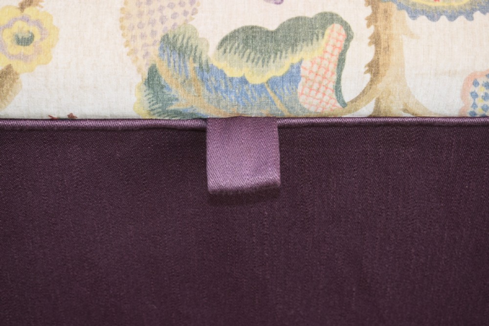 A rectangular Victorian upholstered storage ottoman featuring a deep purple base and a floral patterned fabric lid. View XIII