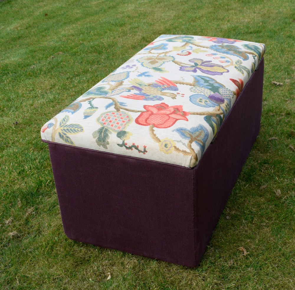 A rectangular Victorian upholstered storage ottoman featuring a deep purple base and a floral patterned fabric lid. View XVI