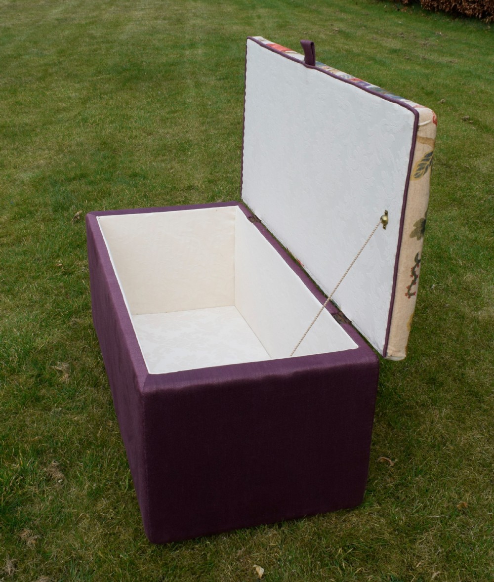 A rectangular Victorian upholstered storage ottoman featuring a deep purple base and a floral patterned fabric lid. View XX