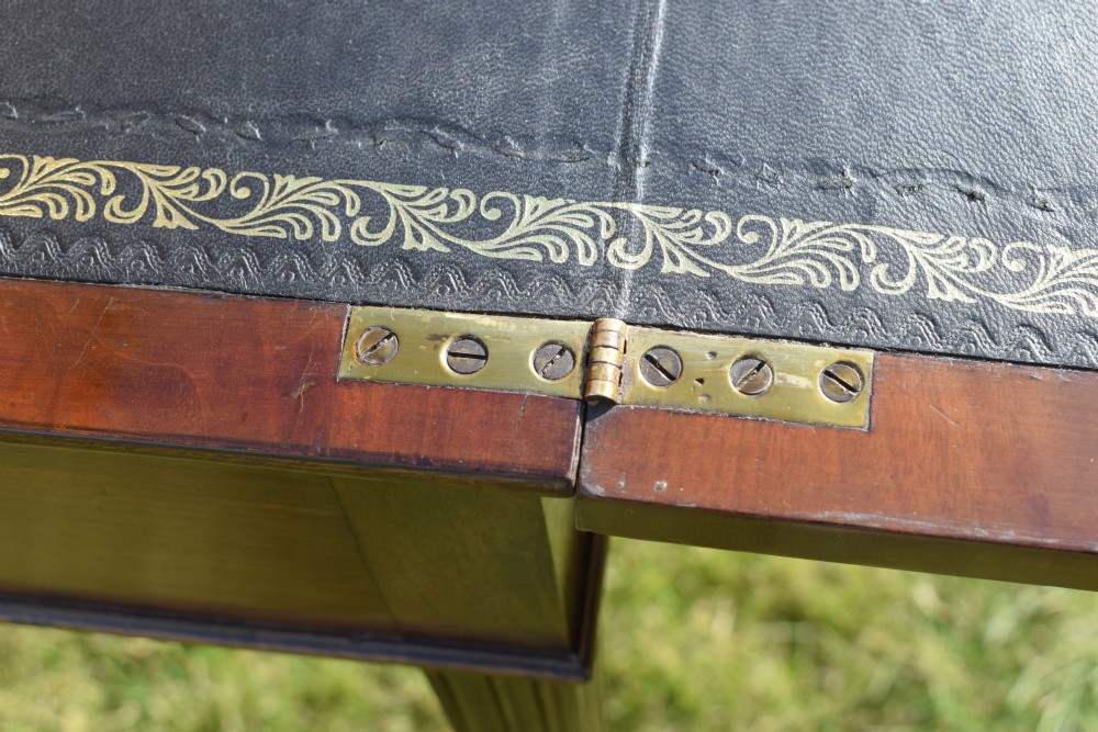 An Edwardian mahogany writing desk featuring a top superstructure with pigeonholes, cupboards, and small drawers above two frieze drawers on fluted tapered legs. View XXIV