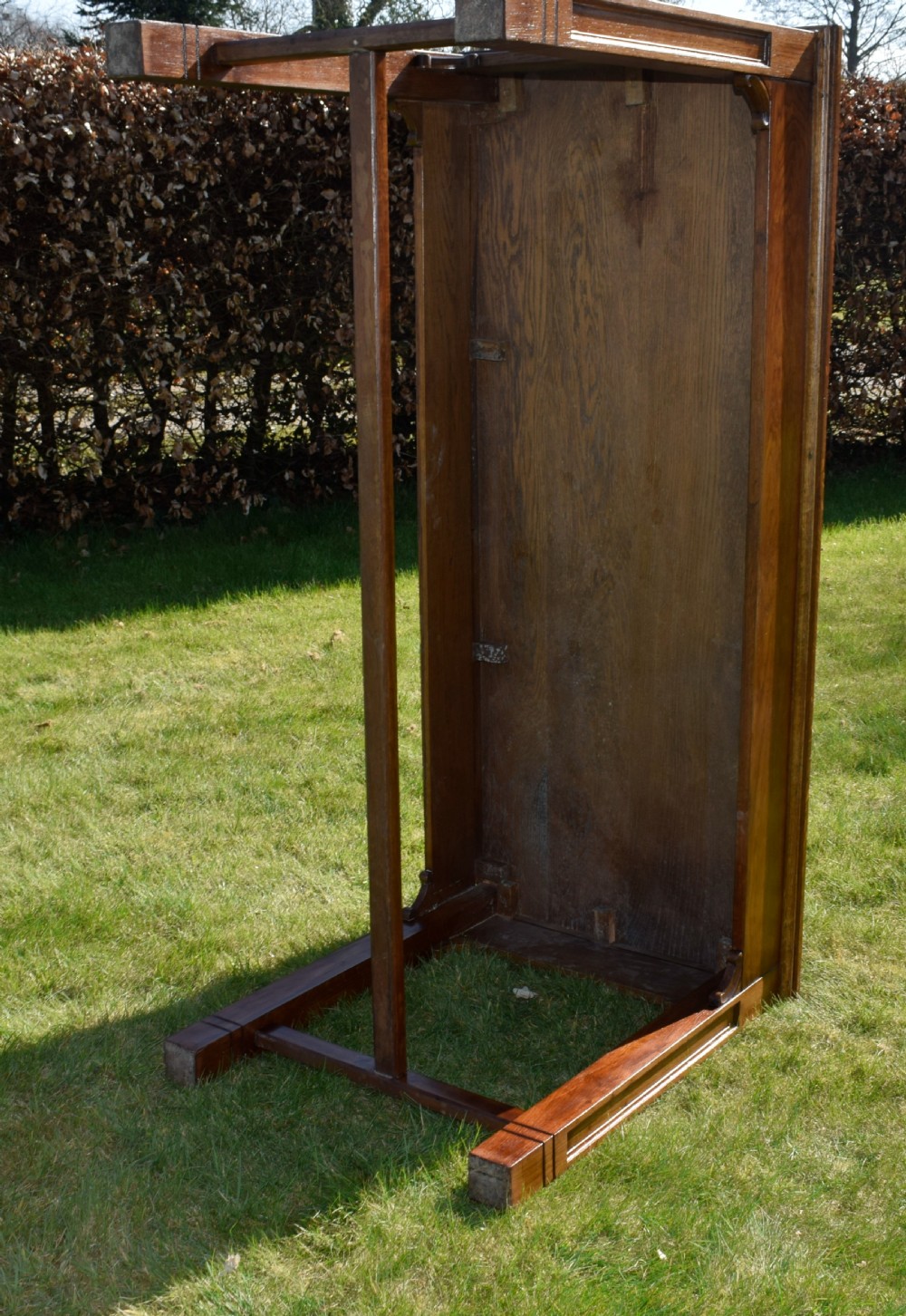 An early 20th-century warm brown rectangular oak dining table featuring square legs with carved detailing and a central low stretcher frame. View XIV