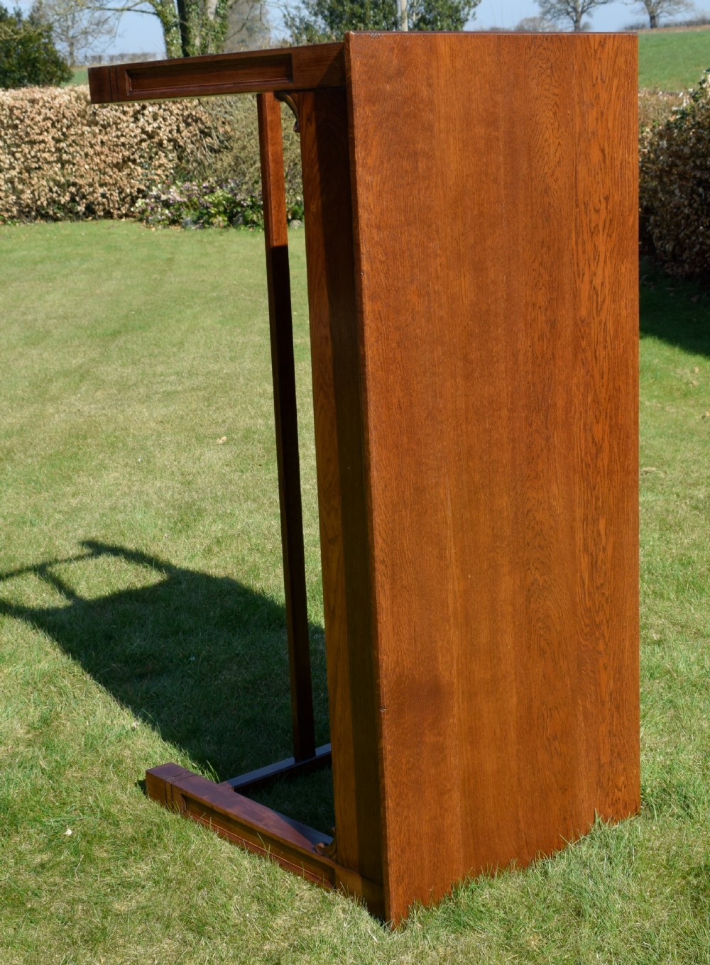 An early 20th-century warm brown rectangular oak dining table featuring square legs with carved detailing and a central low stretcher frame. View XV