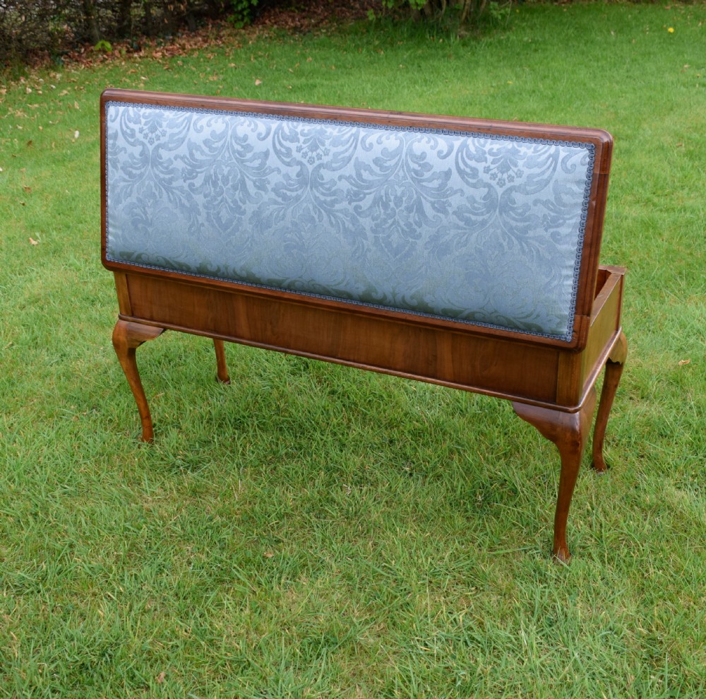 An elongated rectangular wooden duet piano stool featuring cabriole legs and a blue patterned damask upholstered seat trimmed with dark braid. View XVIII