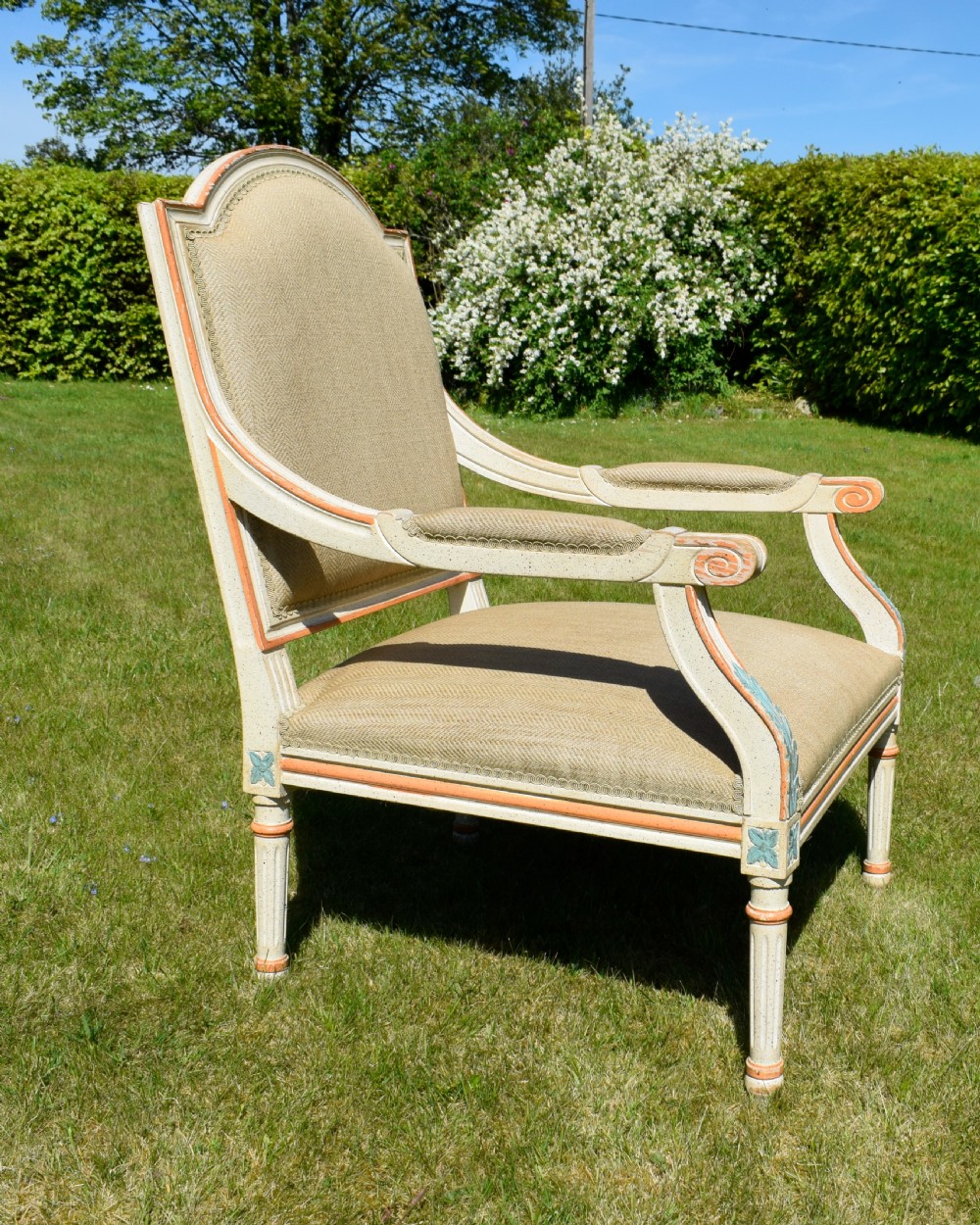 An early 20th-century French Louis XVI style fauteuil armchair featuring a painted off-white frame with fluted legs and beige herringbone fabric upholstery. View X