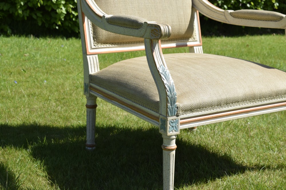 An early 20th-century French Louis XVI style fauteuil armchair featuring a painted off-white frame with fluted legs and beige herringbone fabric upholstery. View XVII