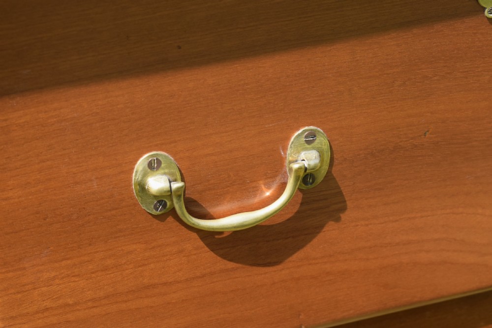 An antique mahogany dresser base featuring two drawers with brass handles, a scalloped apron, and front cabriole legs ending in pad feet. View VIII