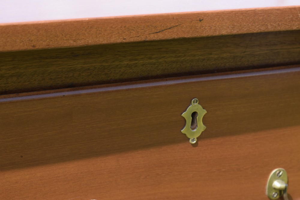 An antique mahogany dresser base featuring two drawers with brass handles, a scalloped apron, and front cabriole legs ending in pad feet. View XVI