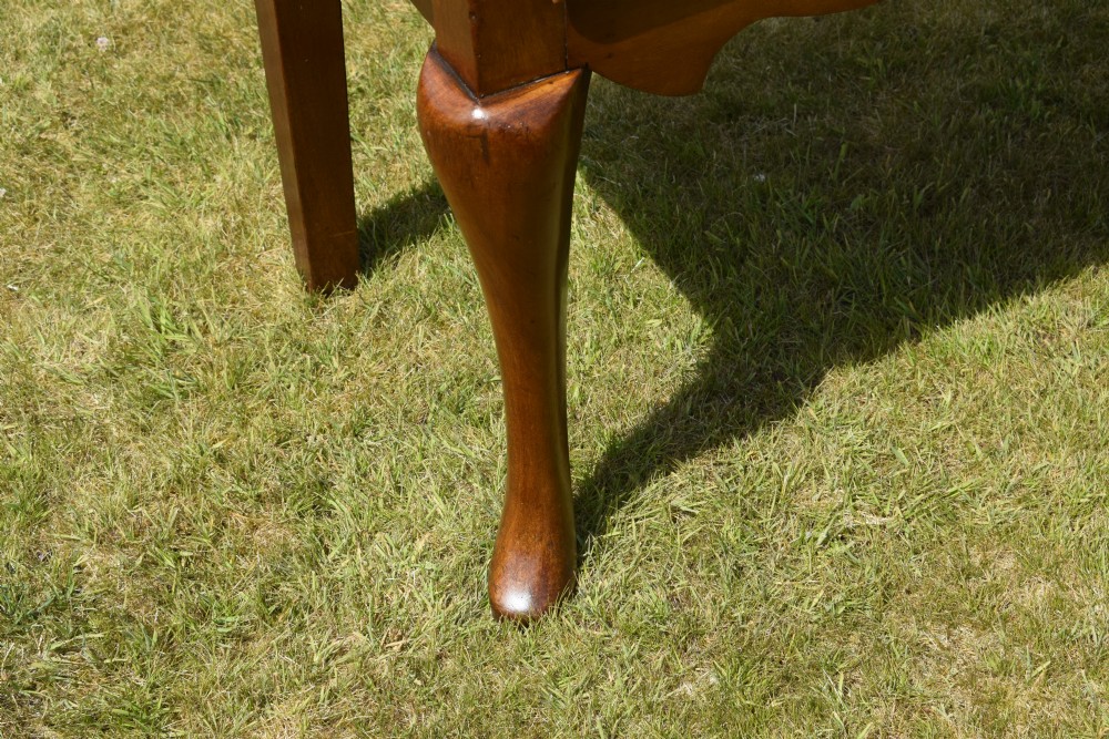 An antique mahogany dresser base featuring two drawers with brass handles, a scalloped apron, and front cabriole legs ending in pad feet. View XIX