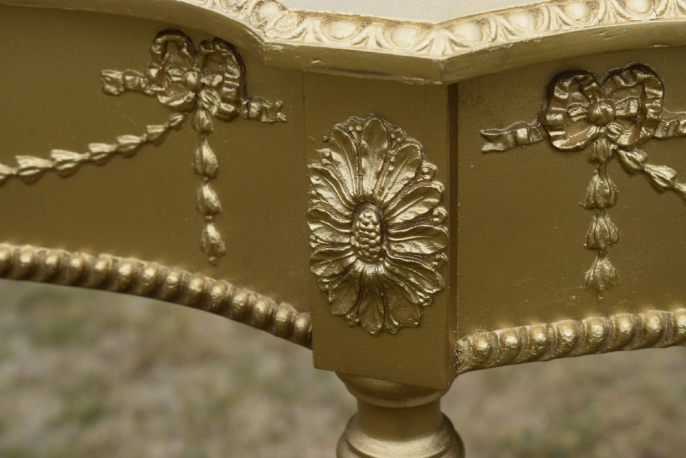 A gold gilded early twentieth-century console table featuring carved swags, a central urn motif, and fluted tapered legs. View XI