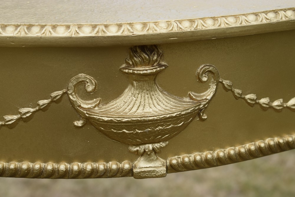 A gold gilded early twentieth-century console table featuring carved swags, a central urn motif, and fluted tapered legs. View XIII