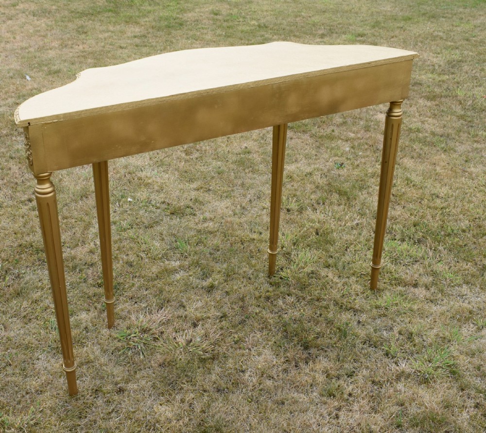A gold gilded early twentieth-century console table featuring carved swags, a central urn motif, and fluted tapered legs. View XVI