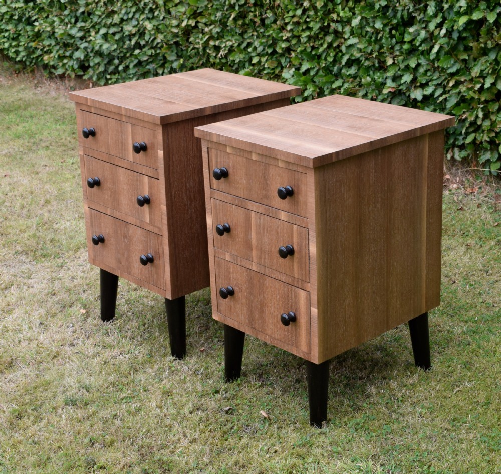 A matching pair of three-drawer walnut bedside chests featuring dark turned knobs and ebonised tapered legs. View VI