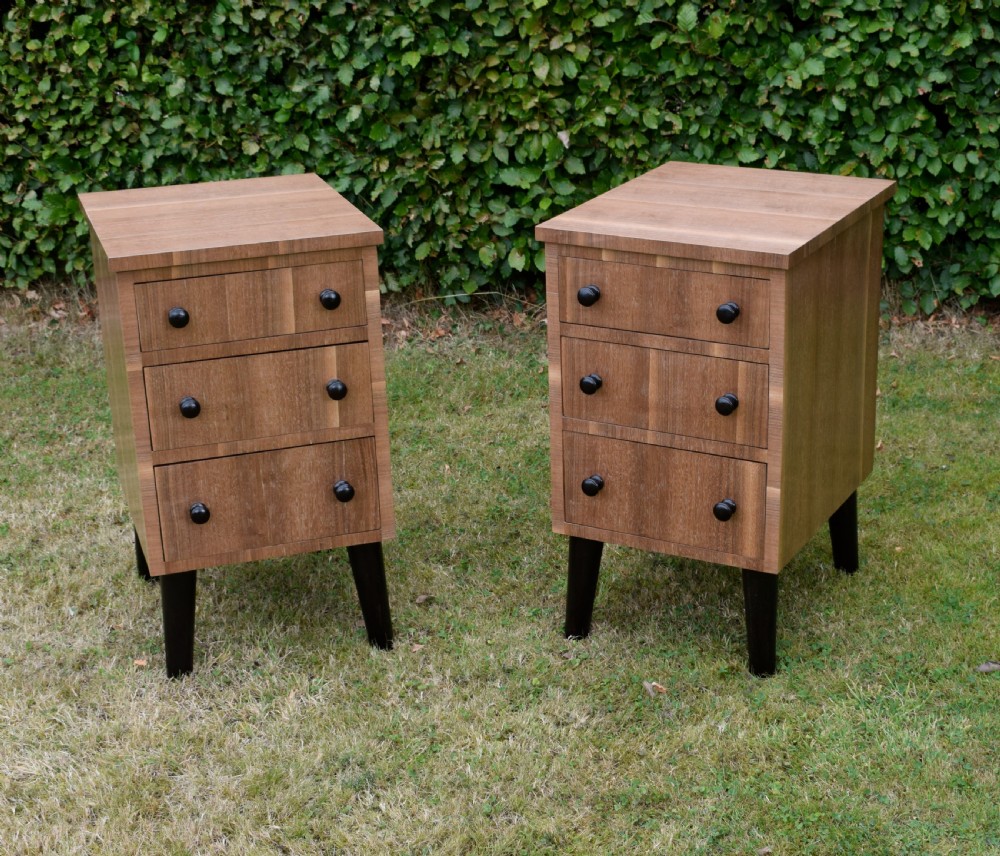 A matching pair of three-drawer walnut bedside chests featuring dark turned knobs and ebonised tapered legs. View XIII