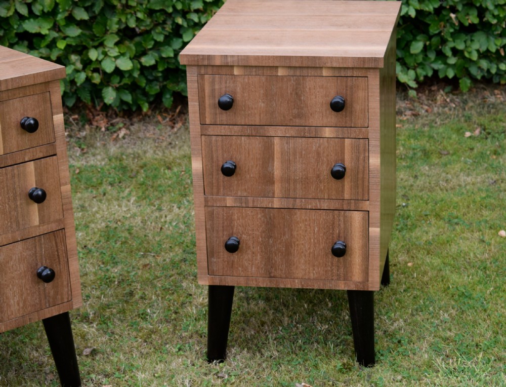 A matching pair of three-drawer walnut bedside chests featuring dark turned knobs and ebonised tapered legs. View XIV
