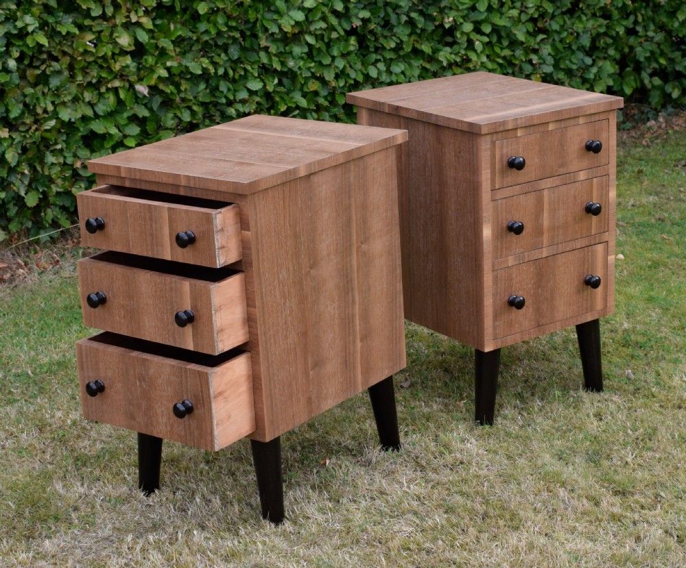 A matching pair of three-drawer walnut bedside chests featuring dark turned knobs and ebonised tapered legs. View XVIII