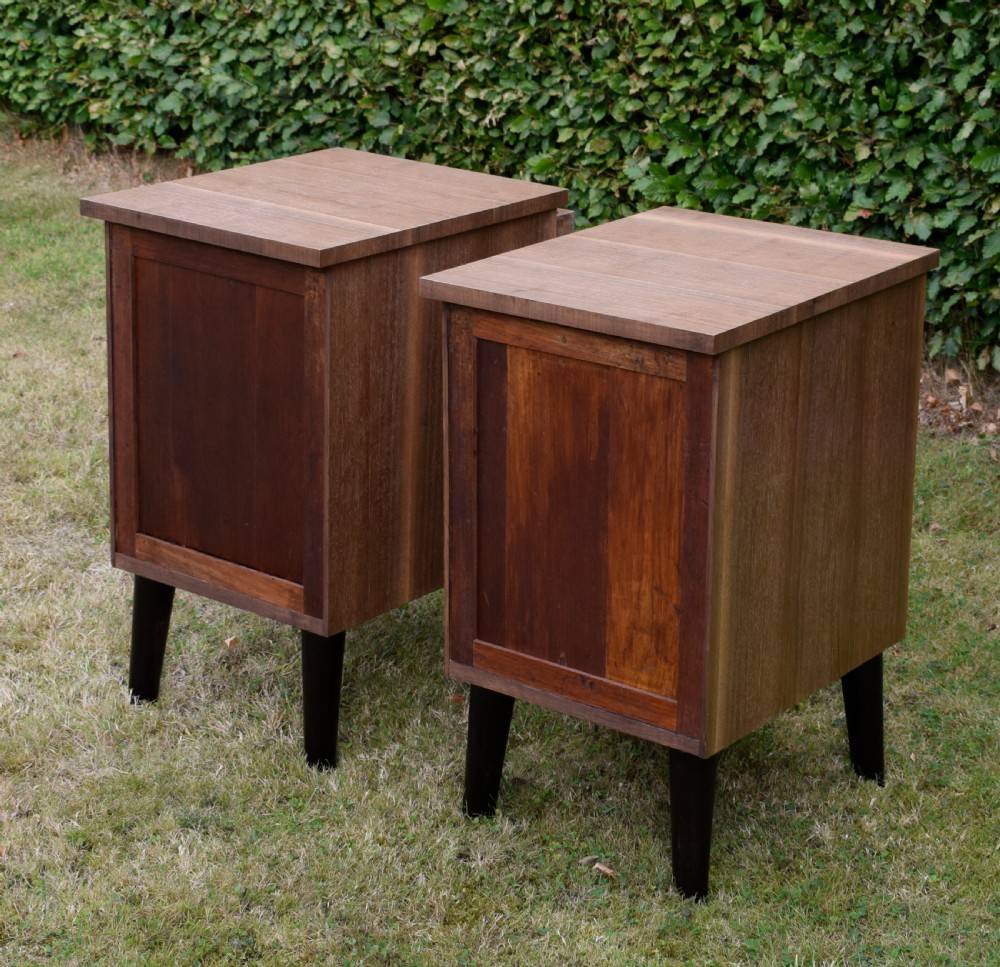 A matching pair of three-drawer walnut bedside chests featuring dark turned knobs and ebonised tapered legs. View XIX