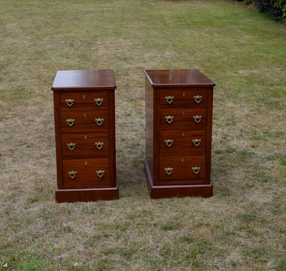 A pair of Victorian mahogany four-drawer bedside chests featuring brass ring handles, escutcheons, and plinth bases. View II
