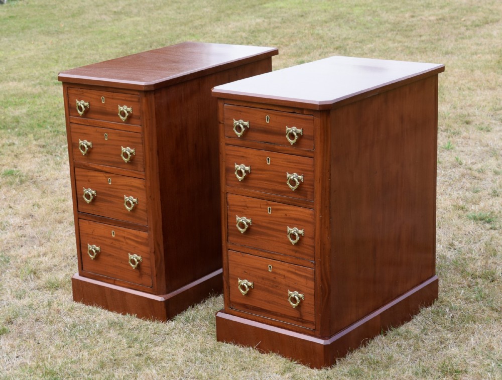 A pair of Victorian mahogany four-drawer bedside chests featuring brass ring handles, escutcheons, and plinth bases. View VII