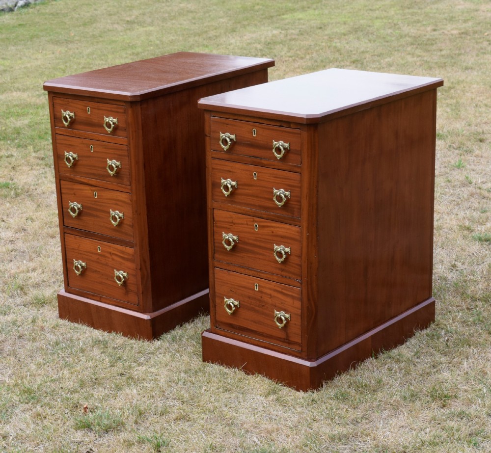 A pair of Victorian mahogany four-drawer bedside chests featuring brass ring handles, escutcheons, and plinth bases. View VIII