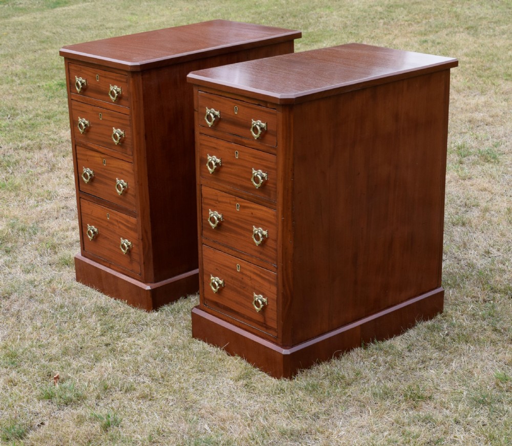 A pair of Victorian mahogany four-drawer bedside chests featuring brass ring handles, escutcheons, and plinth bases. View IX