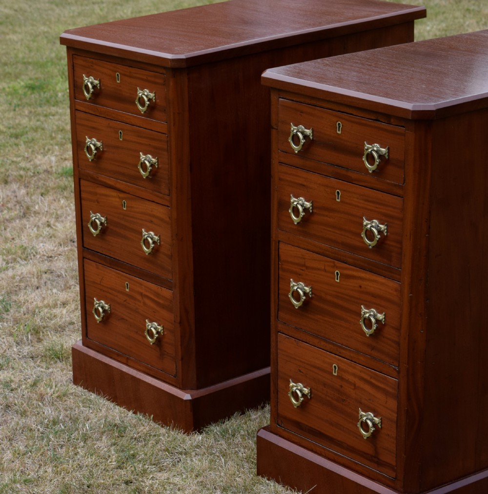 A pair of Victorian mahogany four-drawer bedside chests featuring brass ring handles, escutcheons, and plinth bases. View XI