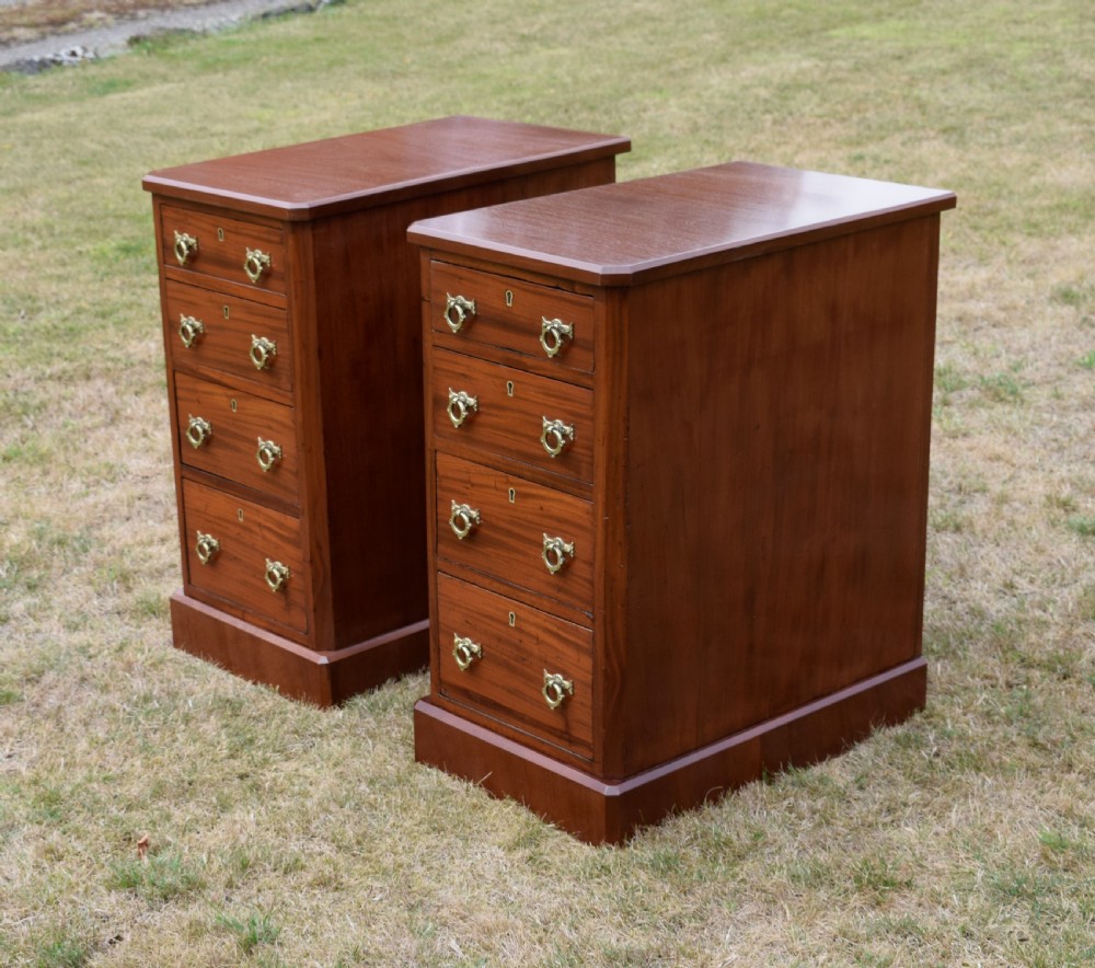 A pair of Victorian mahogany four-drawer bedside chests featuring brass ring handles, escutcheons, and plinth bases. View XII